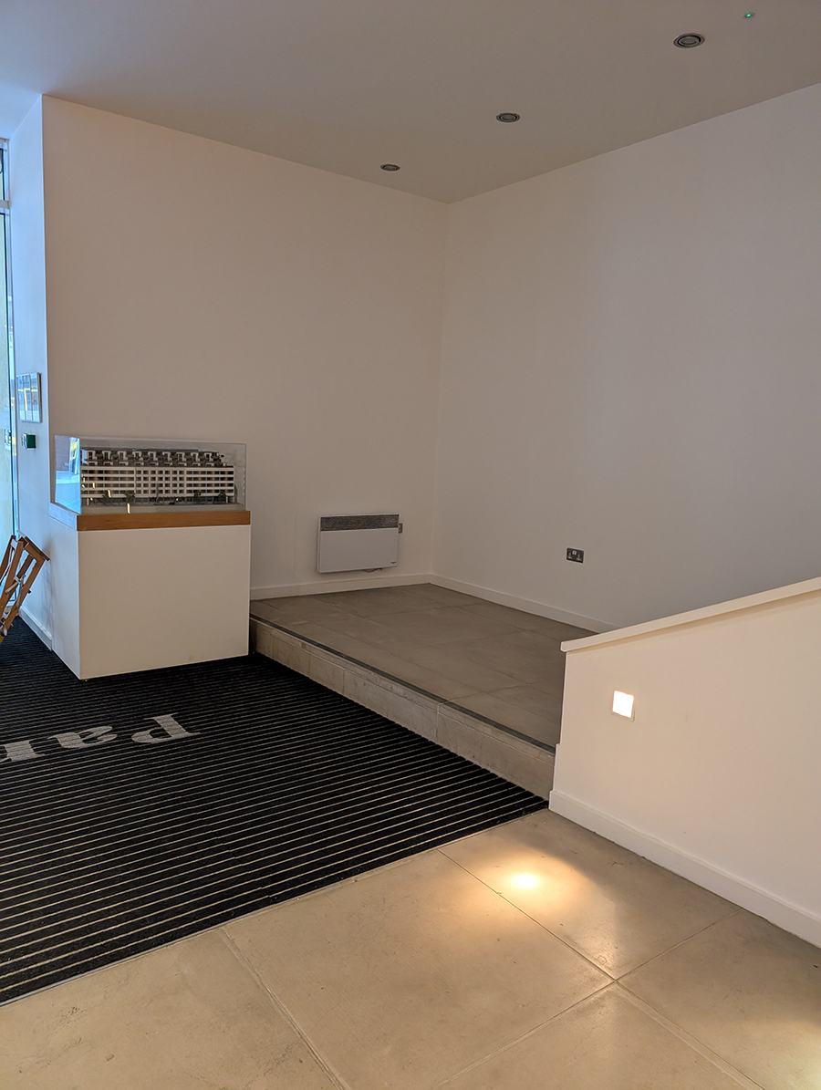 A before photo showing the empty area opposite the concierge desk.