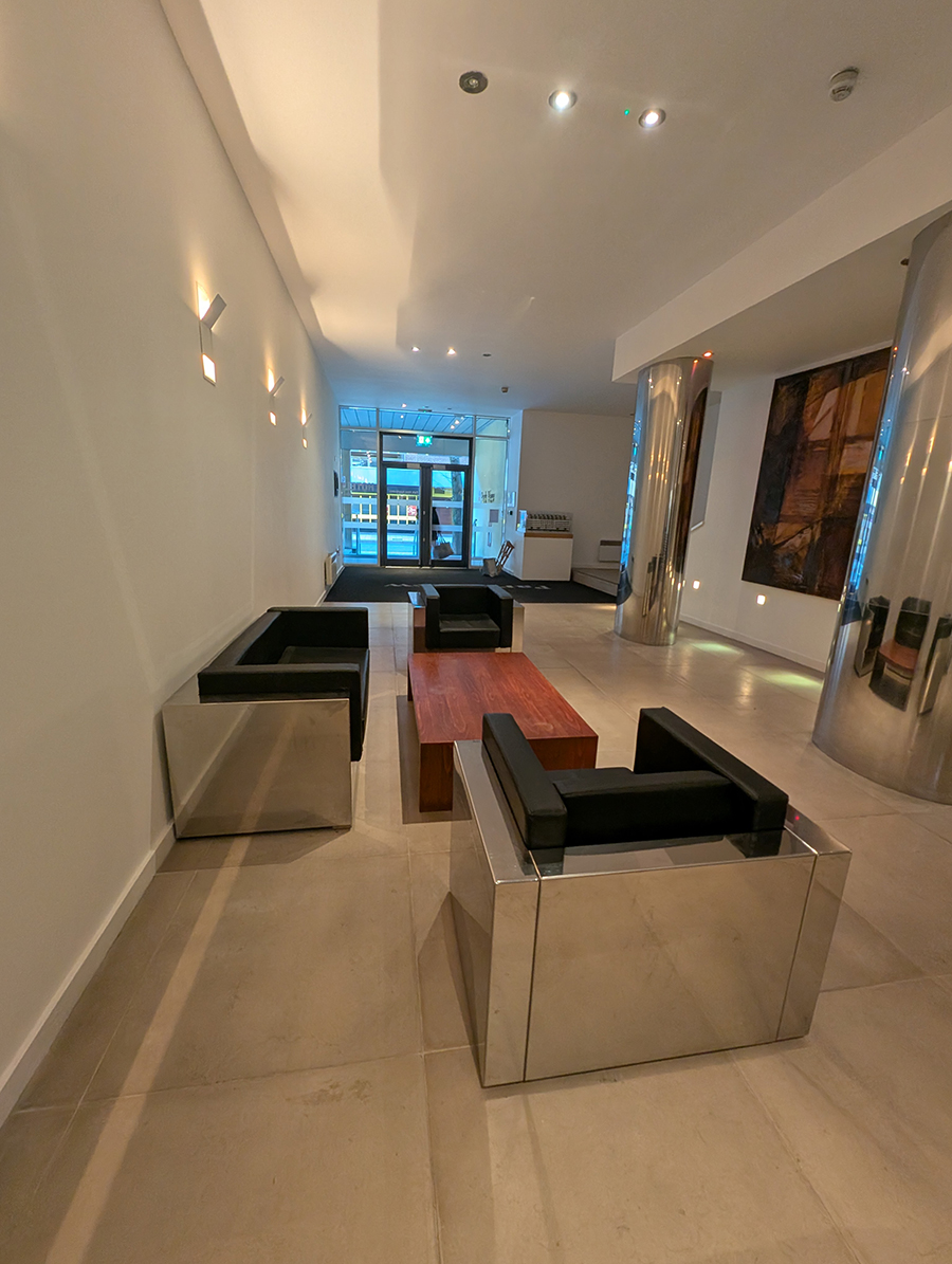 A before photo showing the seating area with chrome furniture.