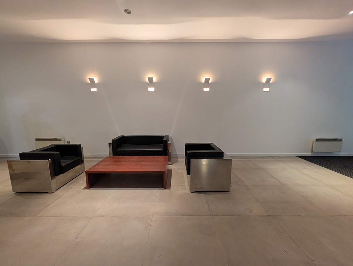 A before photo of the seating area looking drab and uninviting.