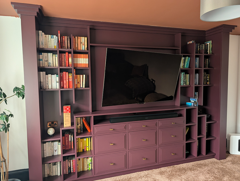 A large plum coloured media wall 