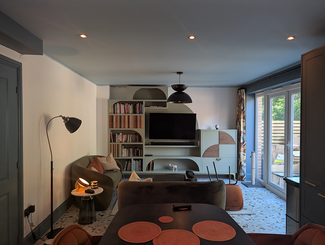 A kitchen snug with bespoke green curved media wall 