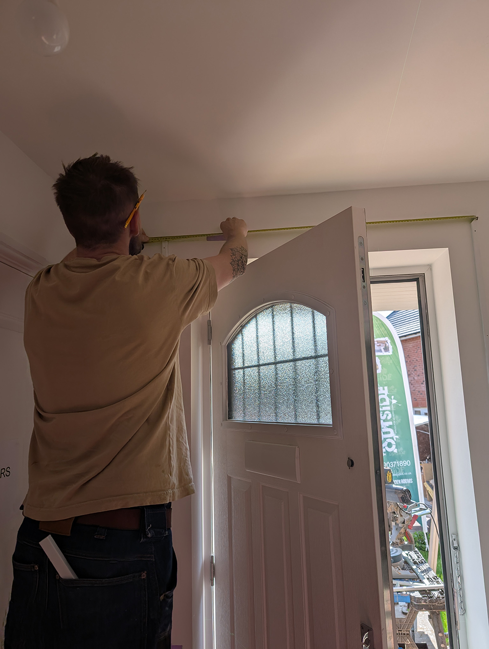 A carpenter installing wooden beading to a wall