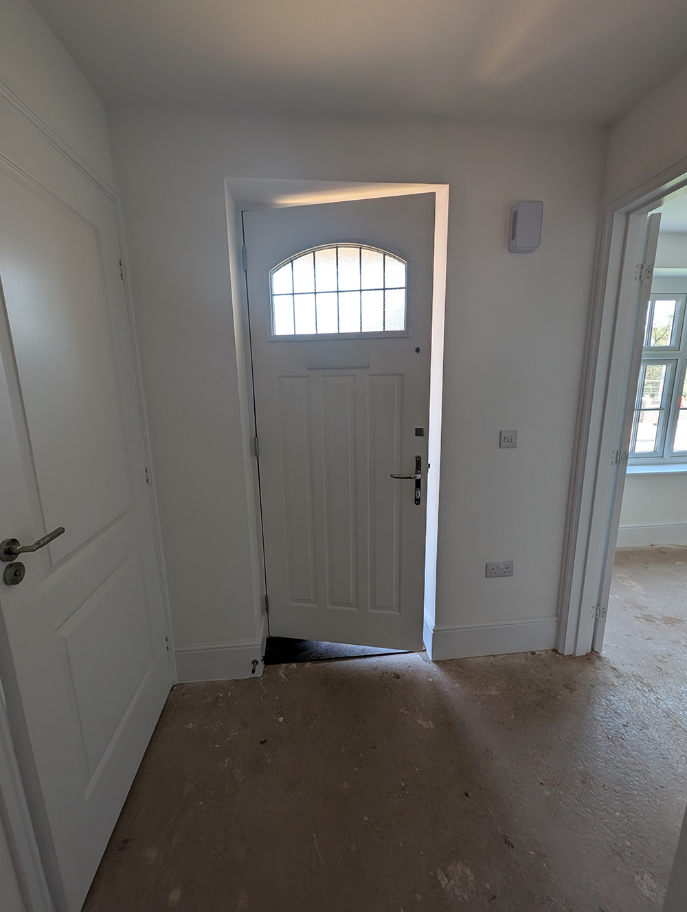 A hallway with white walls and ceiling 