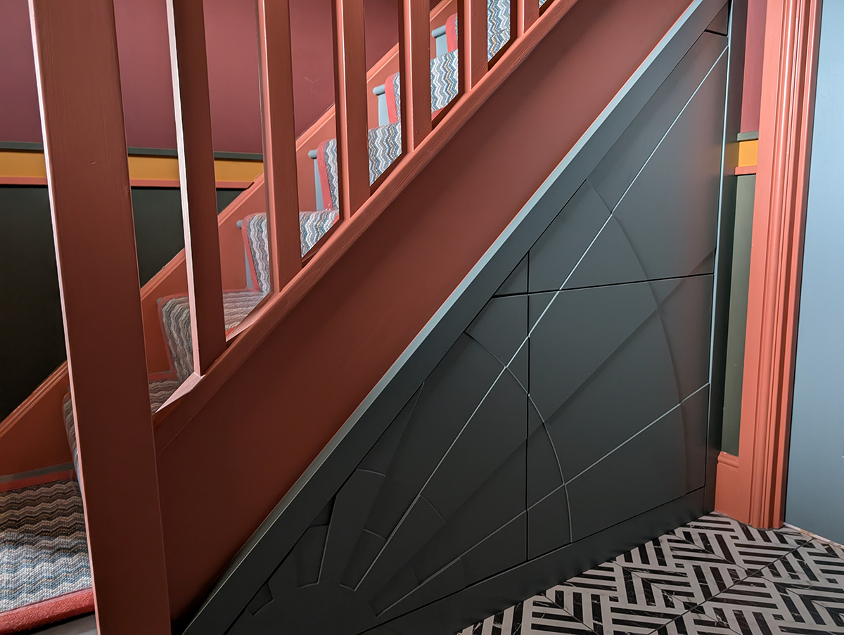 An under stairs cupboard with a sunbeam design 