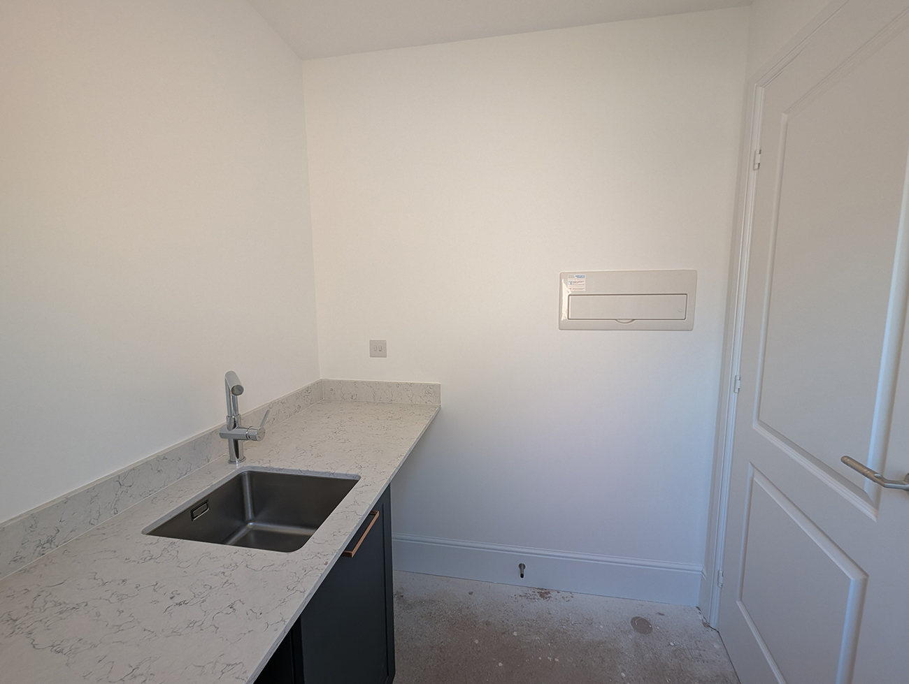 A utility room with all white walls and ceiling 