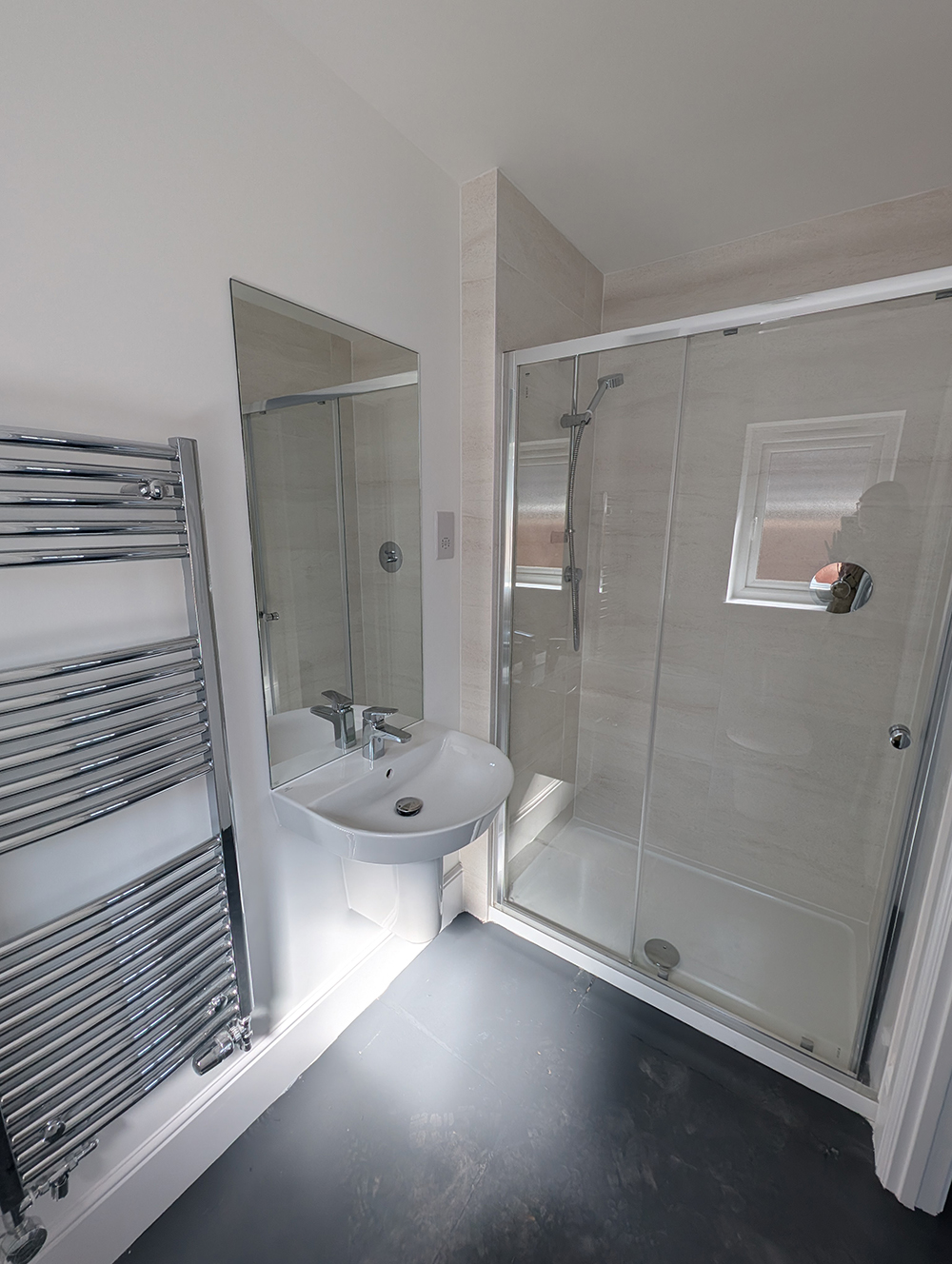 A new build en suite with white walls and fittings