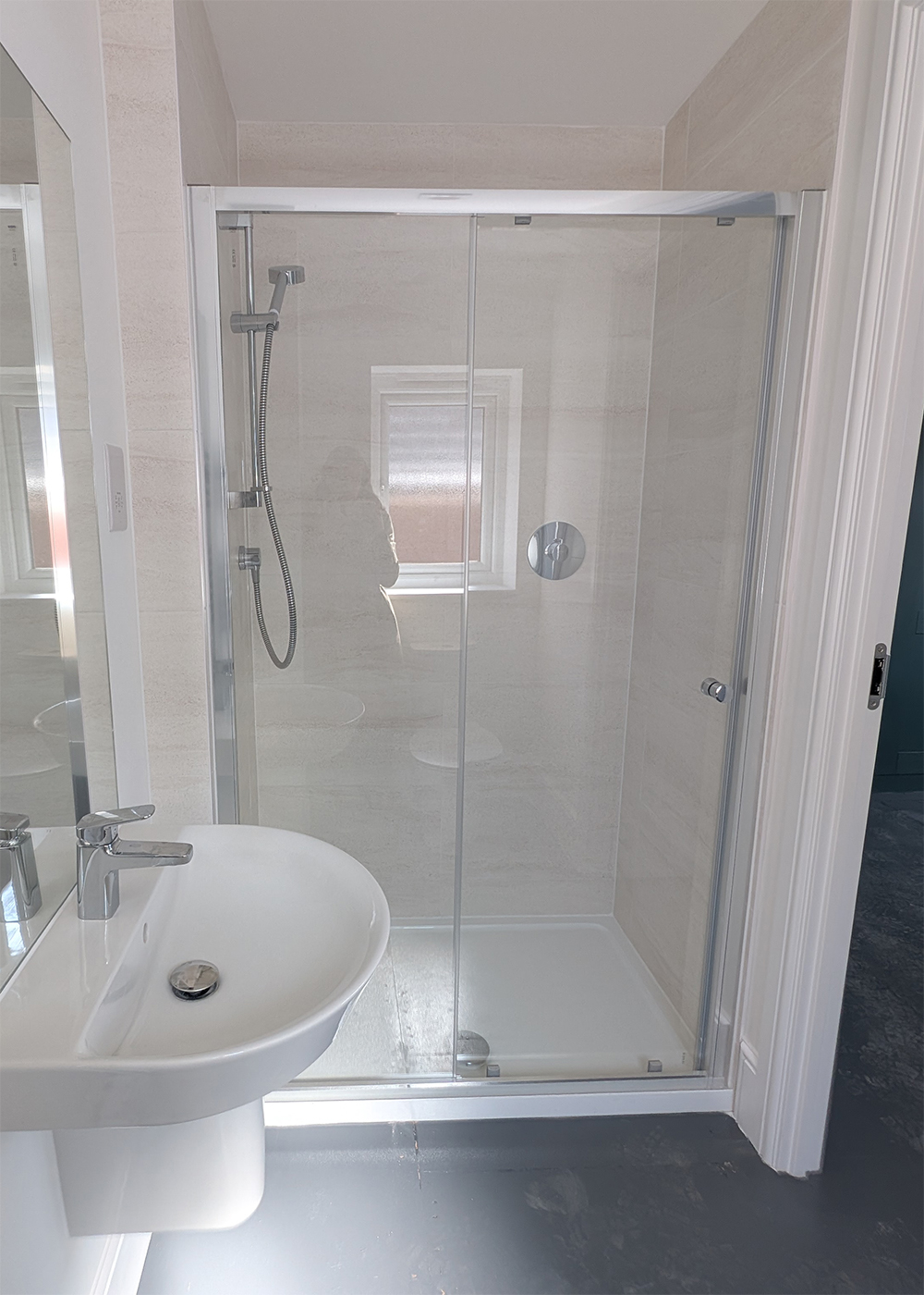 A new build en suite with white walls and fittings