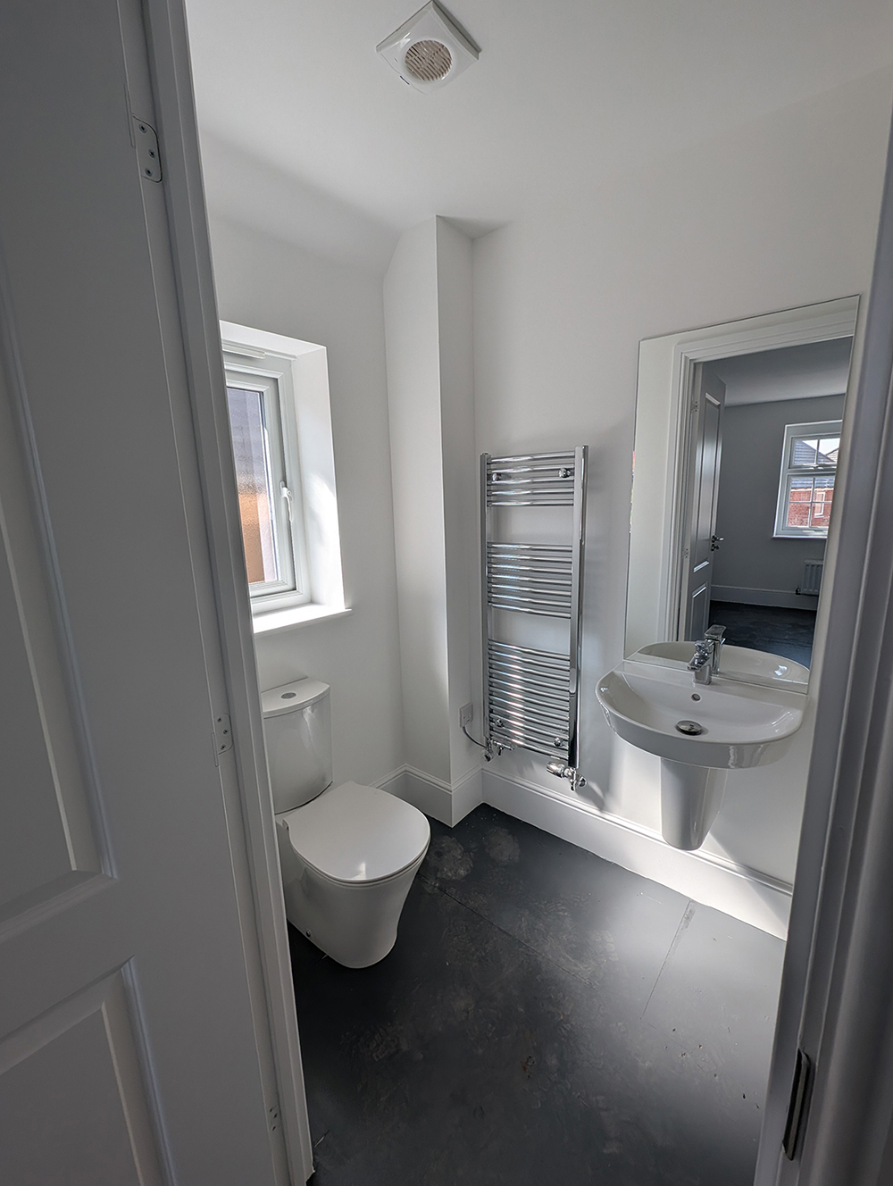 A new build en suite with white walls and fittings