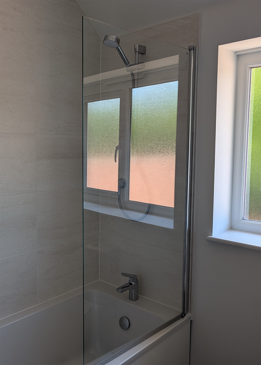 A new build bathroom with beige tiles