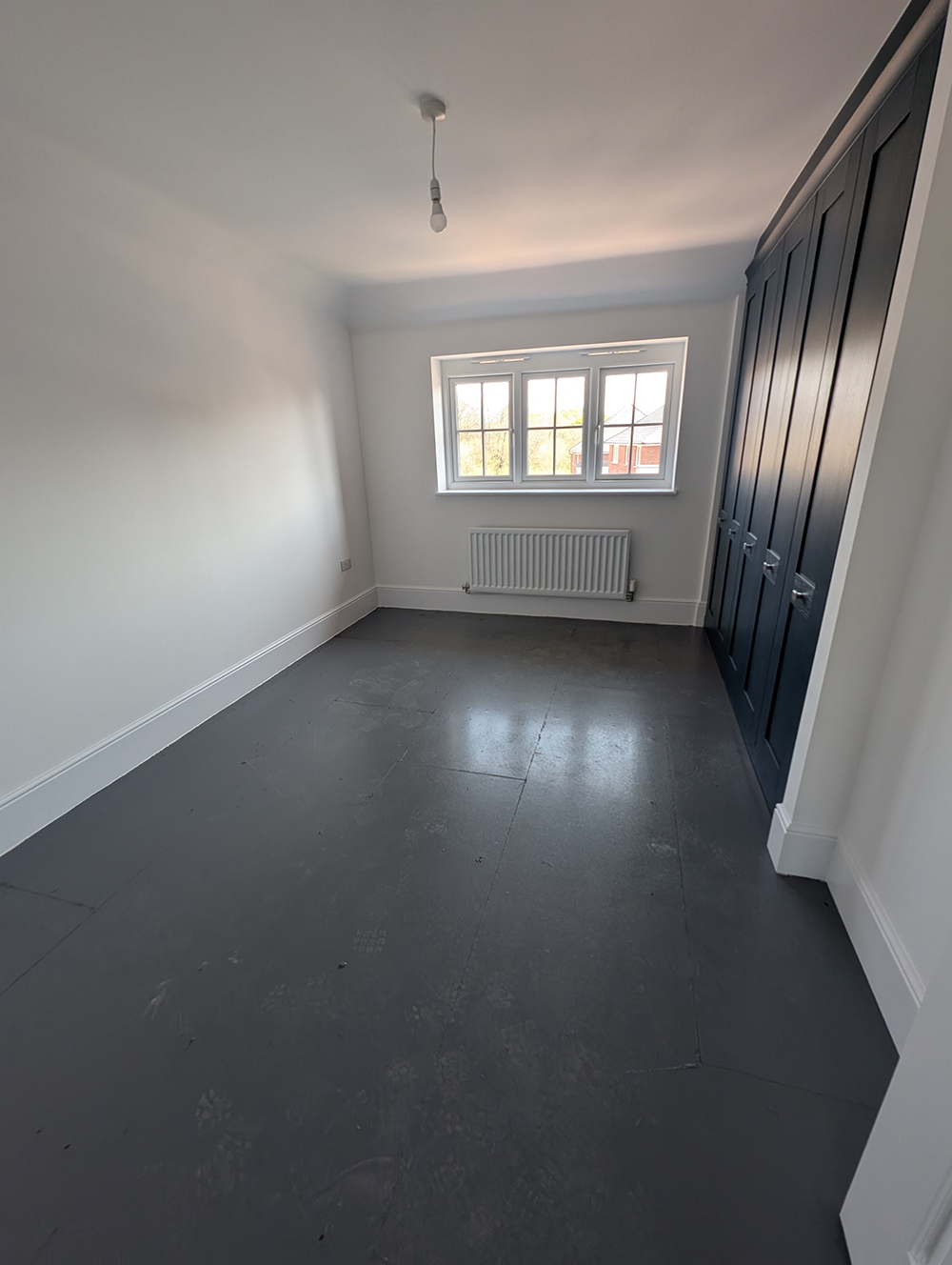 A new build bedroom with navy built in wardrobes