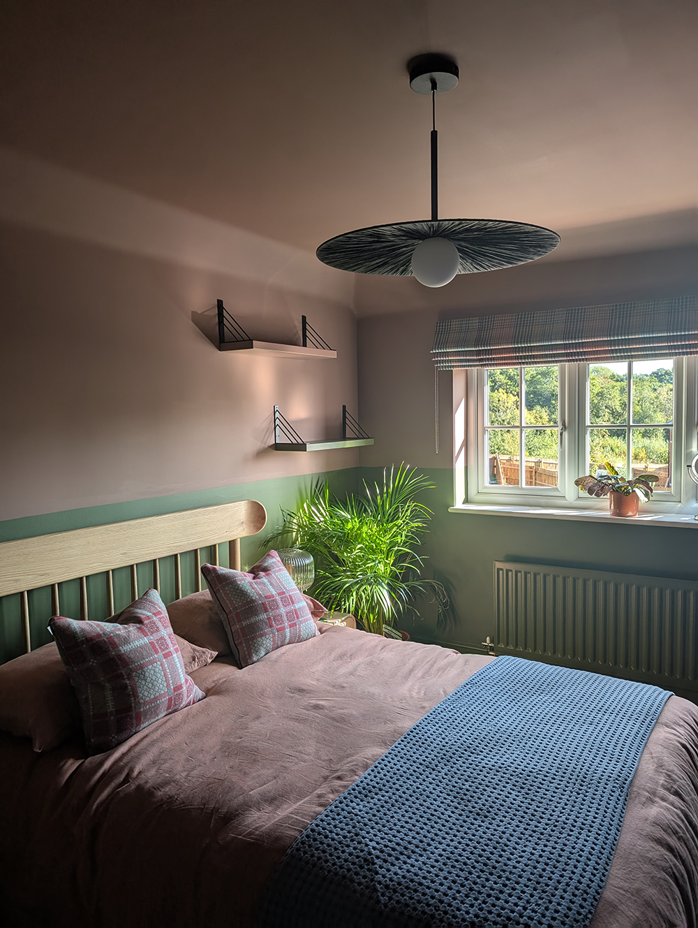 A new build guest bedroom with pink and green walls