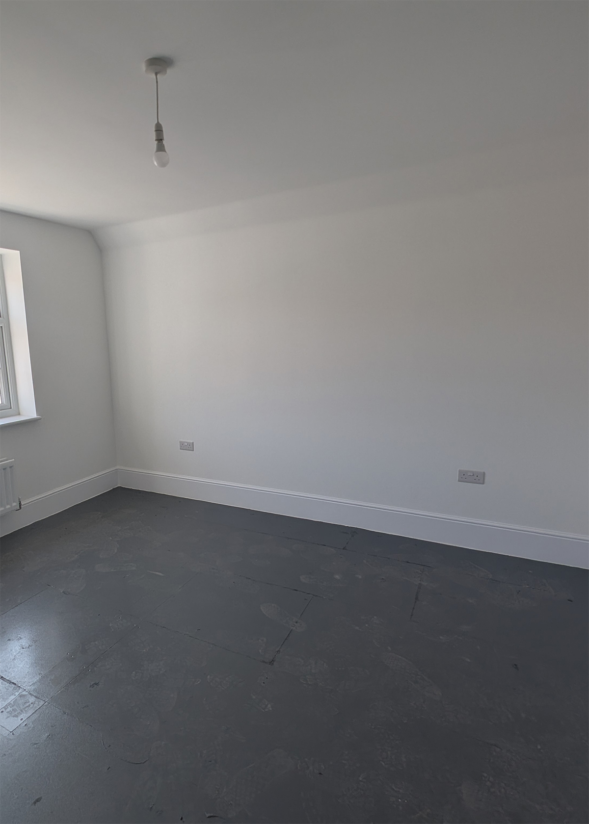 A new build bedroom with white walls