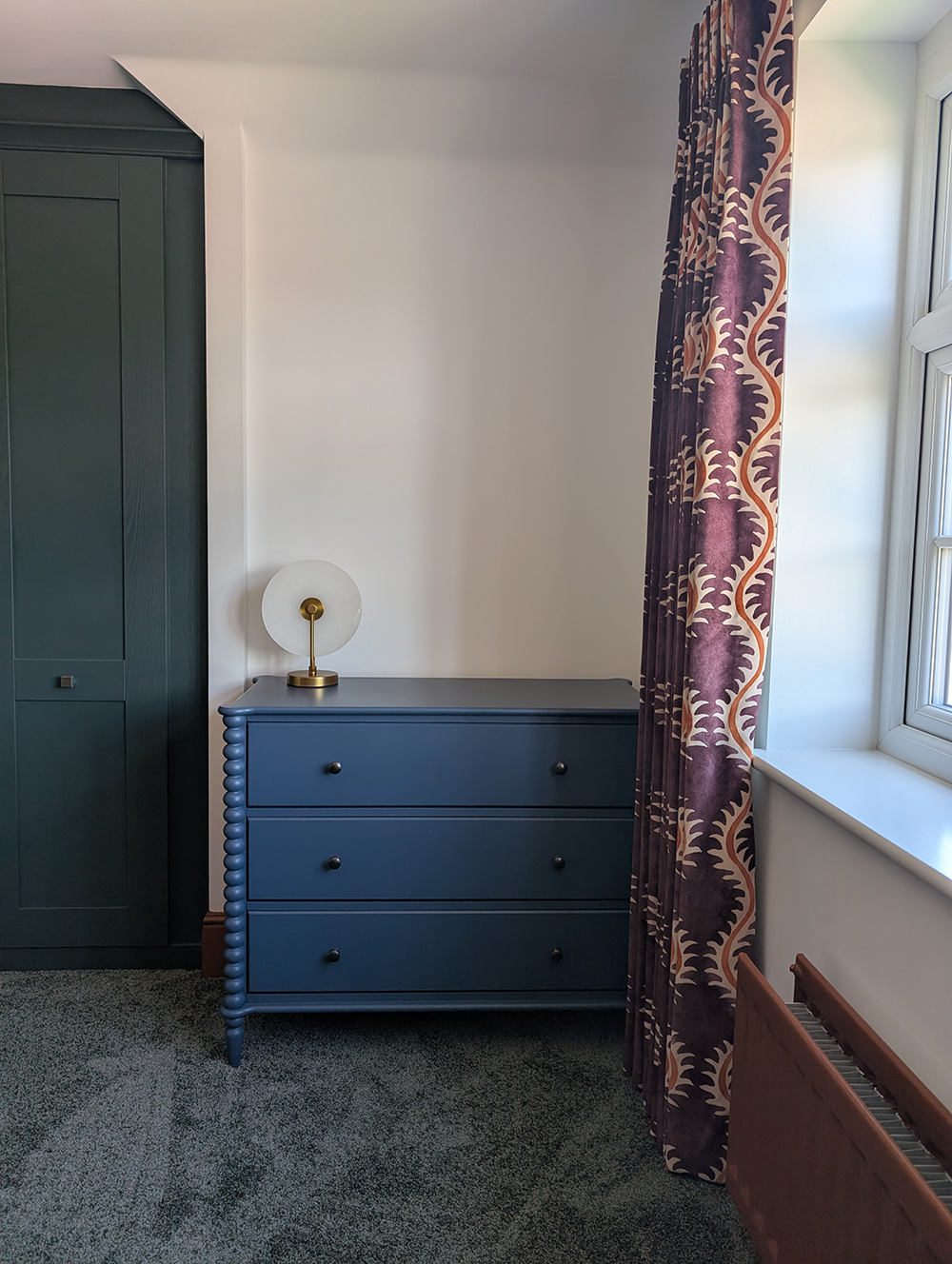 A new build bedroom with green wardrobes