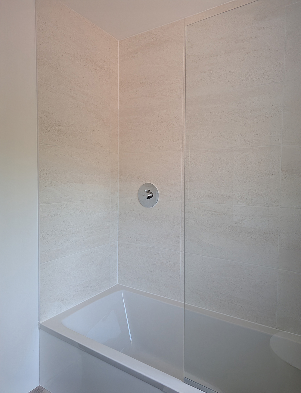 A new build bathroom with beige tiles