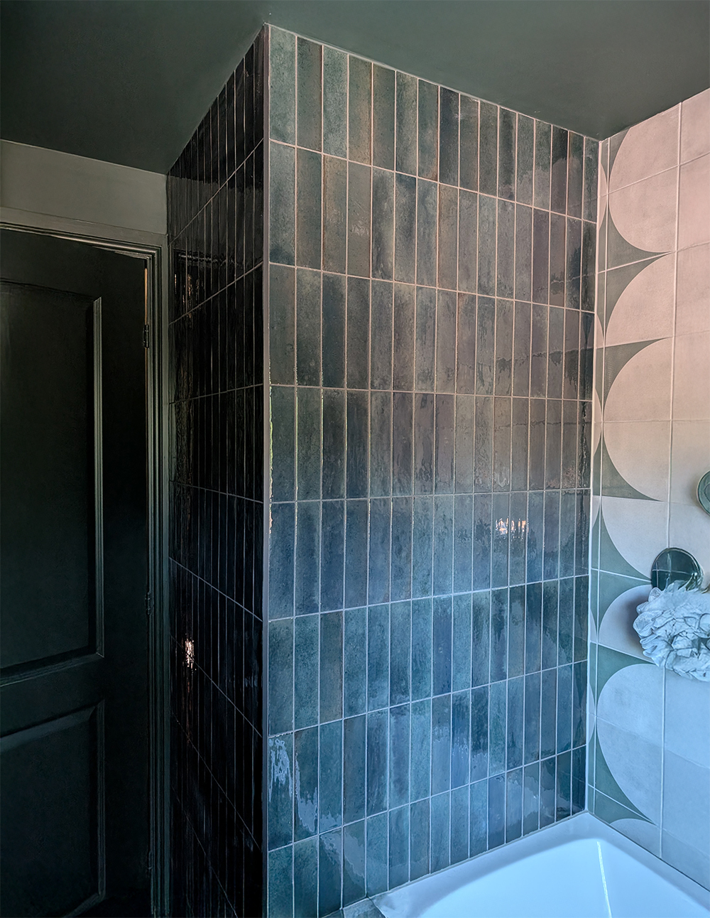 A new build bathroom with dark green tiles