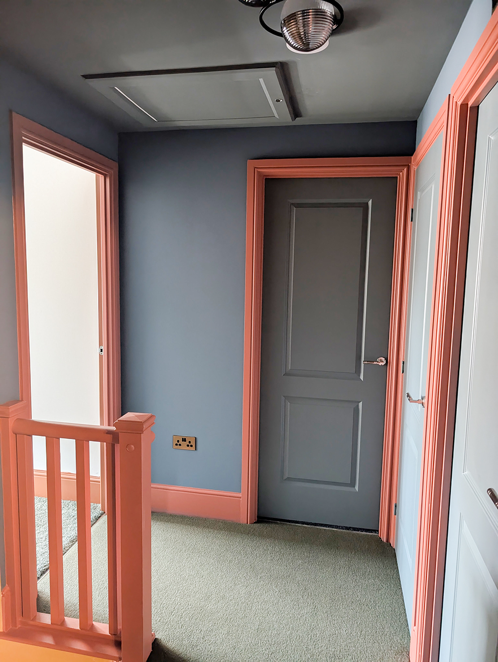 A new build landing with colourful woodwork