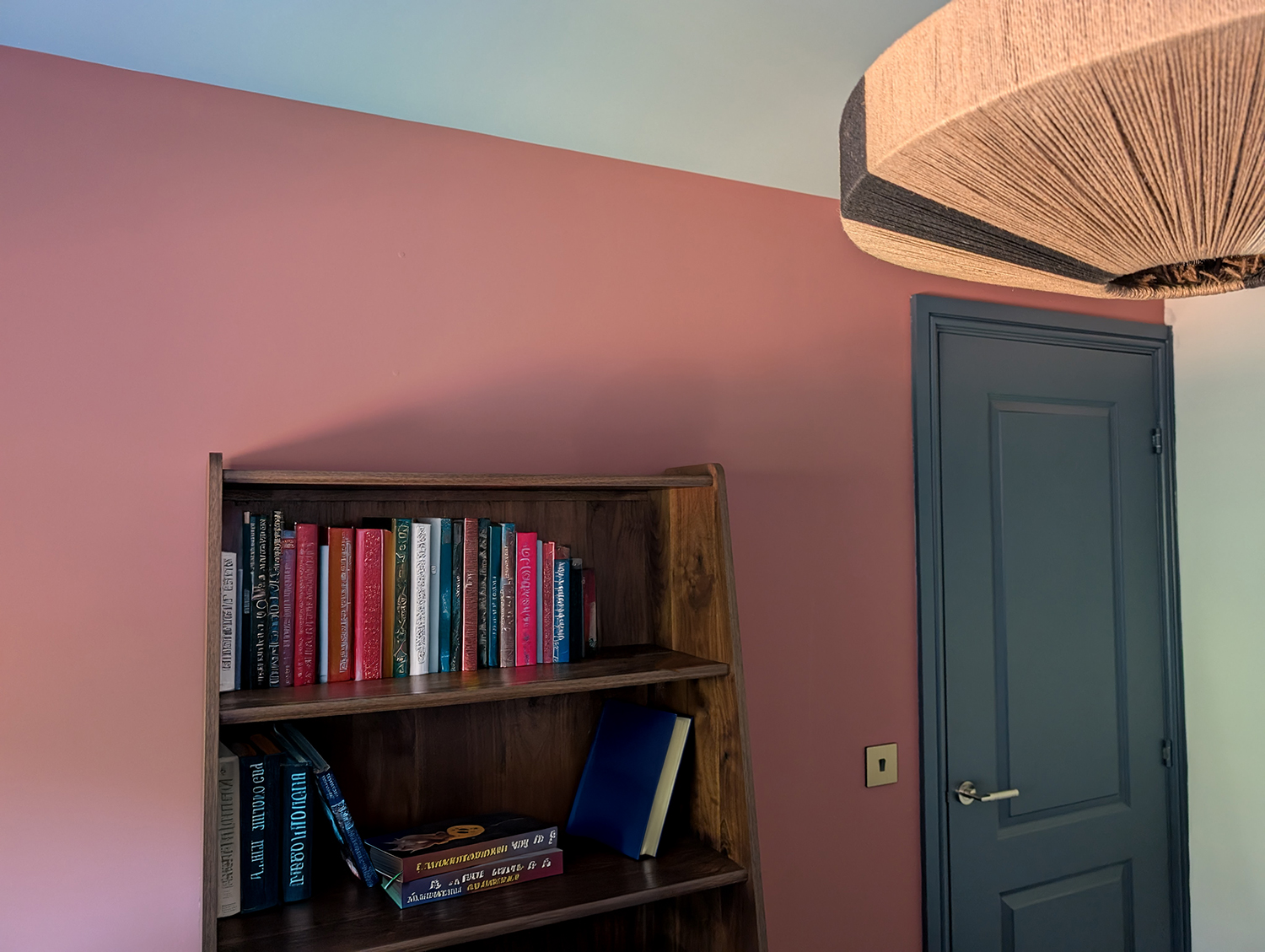 A new build home office with dusky pink walls and blue ceiling