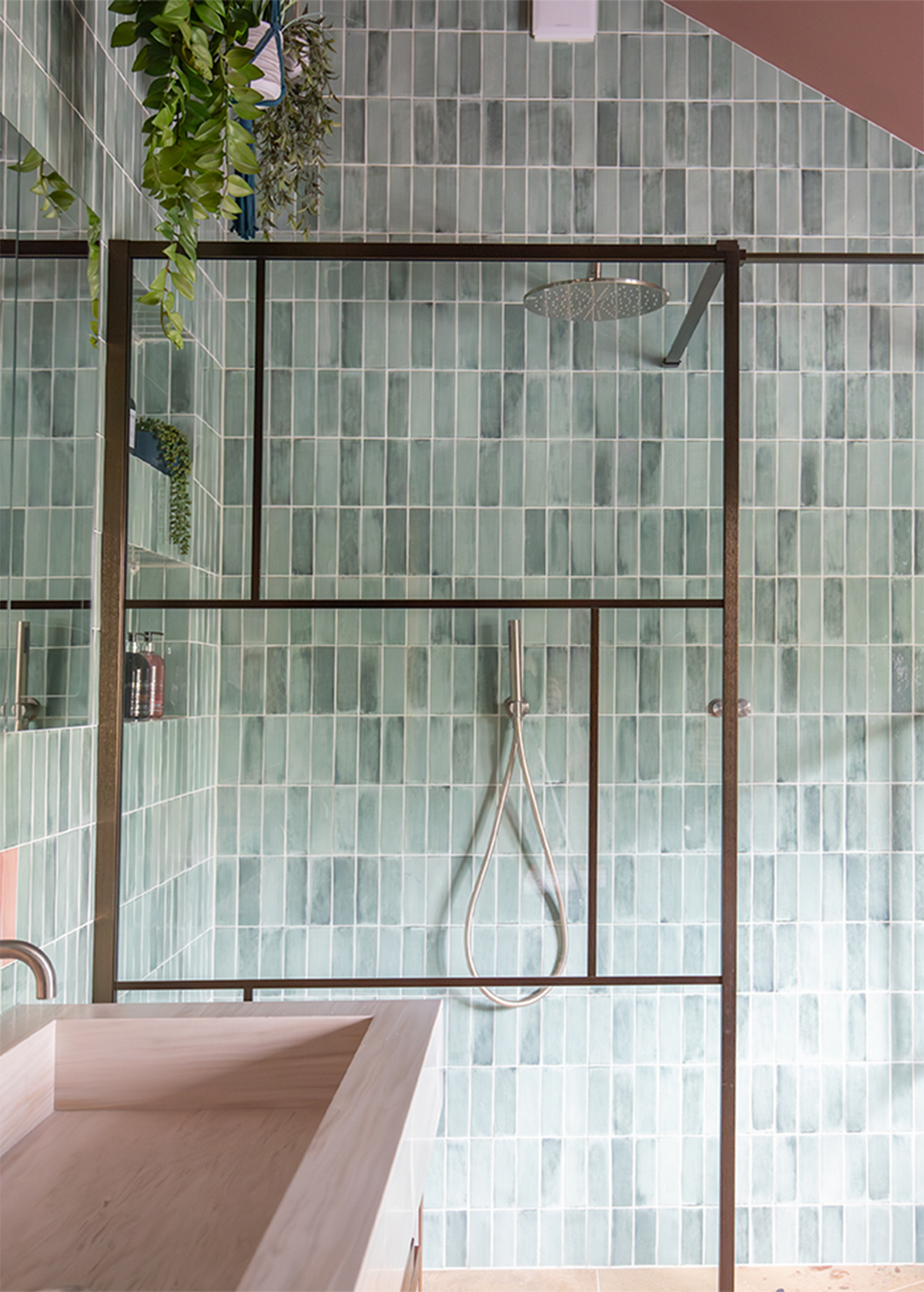 A tiled shower area with black lead screen 