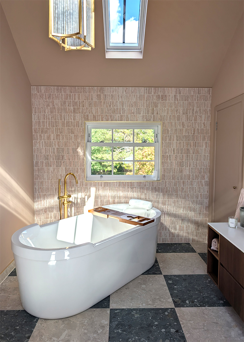 A photo of the finished en suite with the bath in front of the window.
