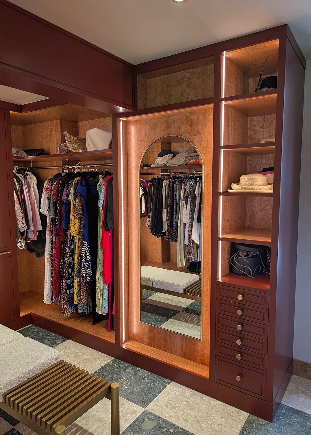 A photo of the finished dressing room with burgundy wardrobes and LED lighting.