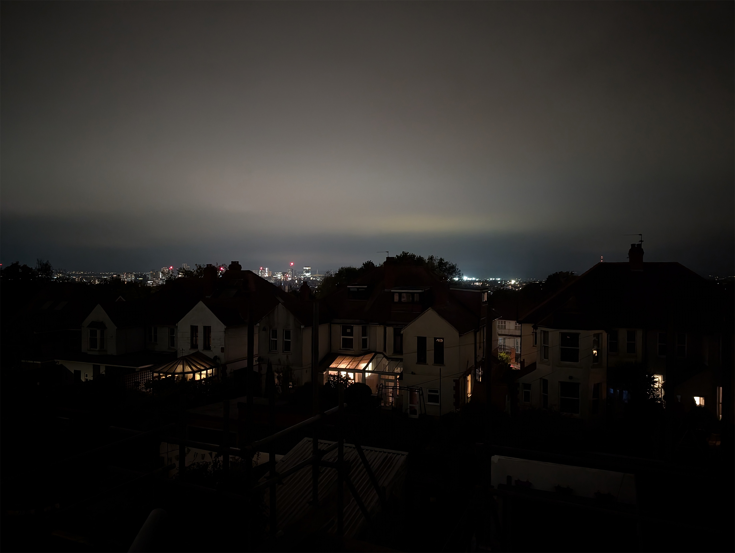 A view from the sliding doors showing Cardiff lit up at night.