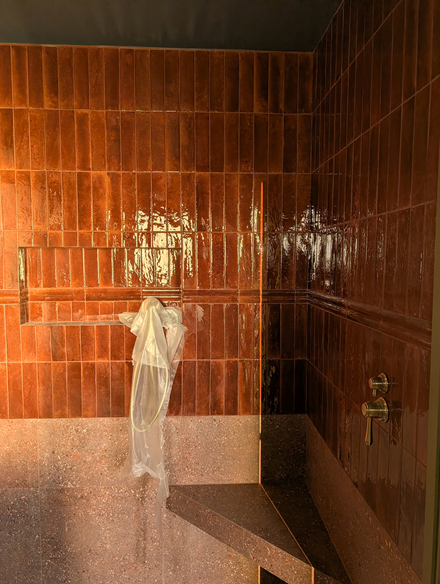 A photo showing the shower seat and tiled en suite.