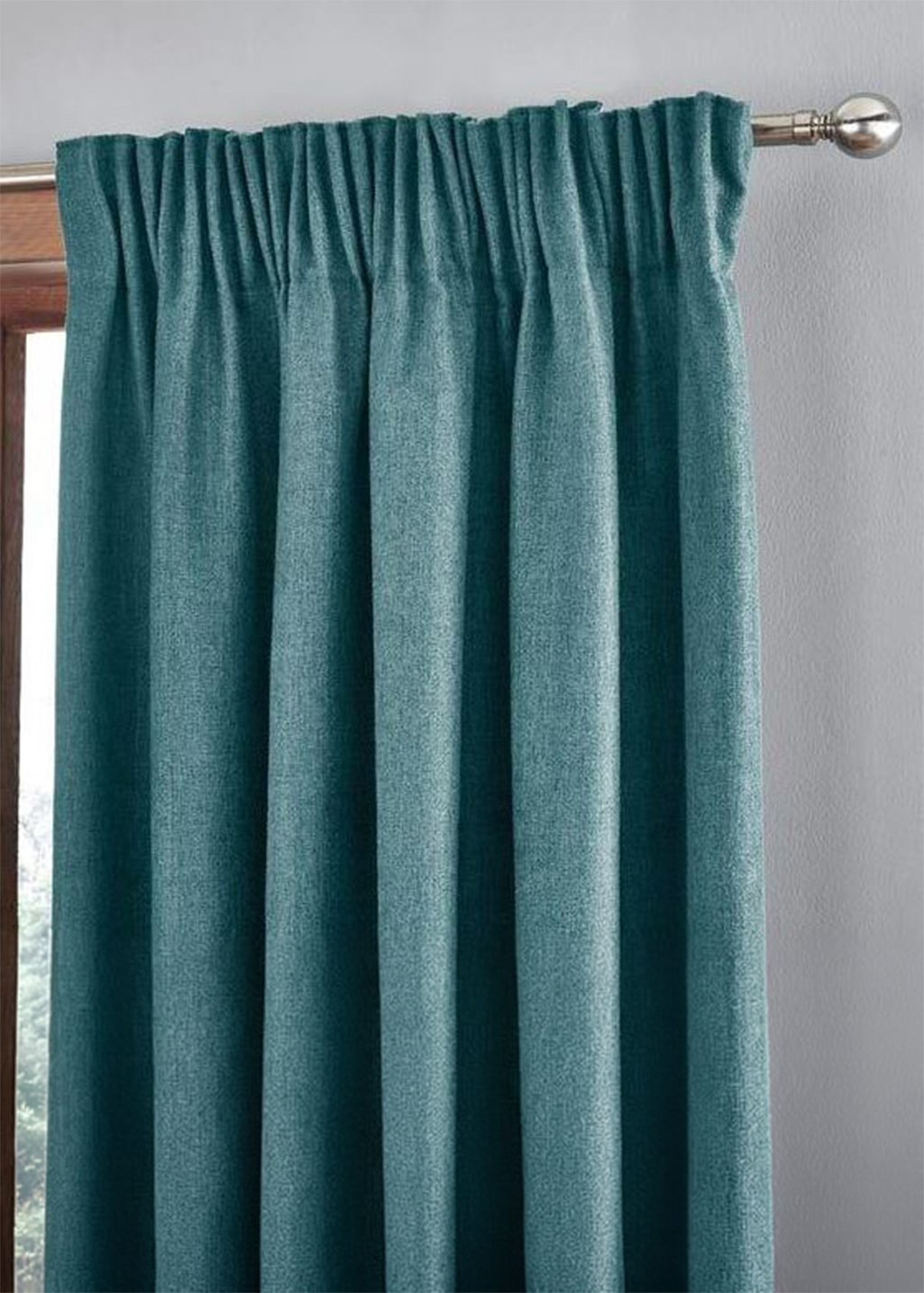 A photo of a pencil pleat heading curtain at a window.