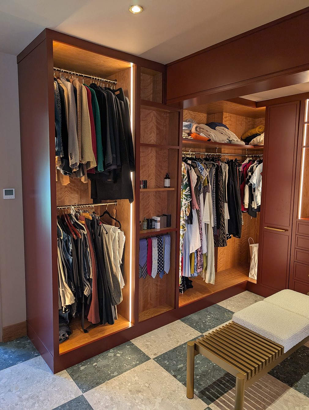 A photo of the dressing room storage finished in burgundy and oak.
