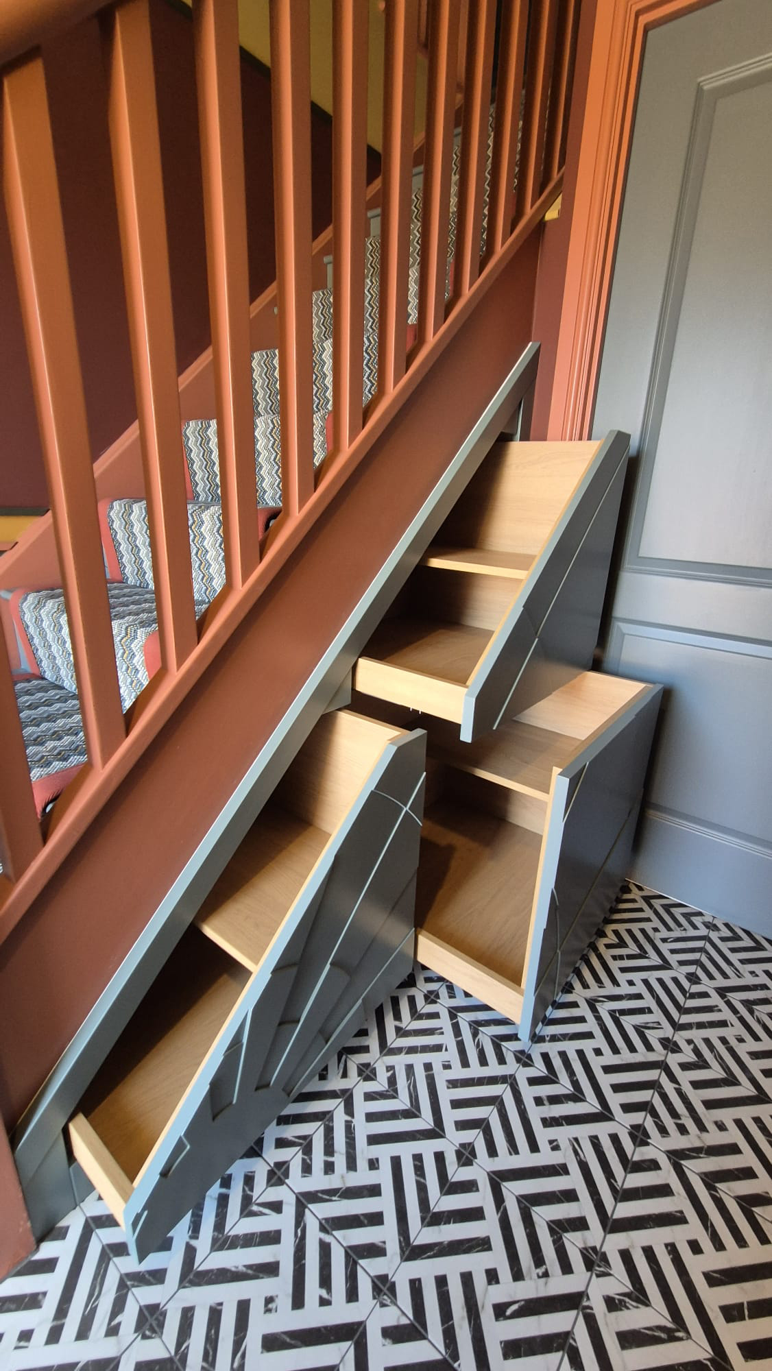 A photo of some understair storage with the drawers open from our new build project.