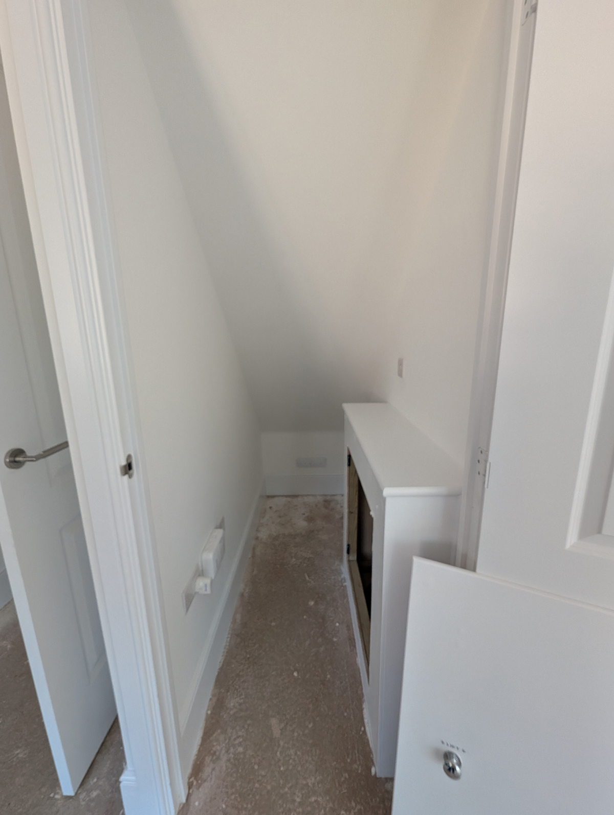 A photo of the understairs storage accessed from the kitchen.