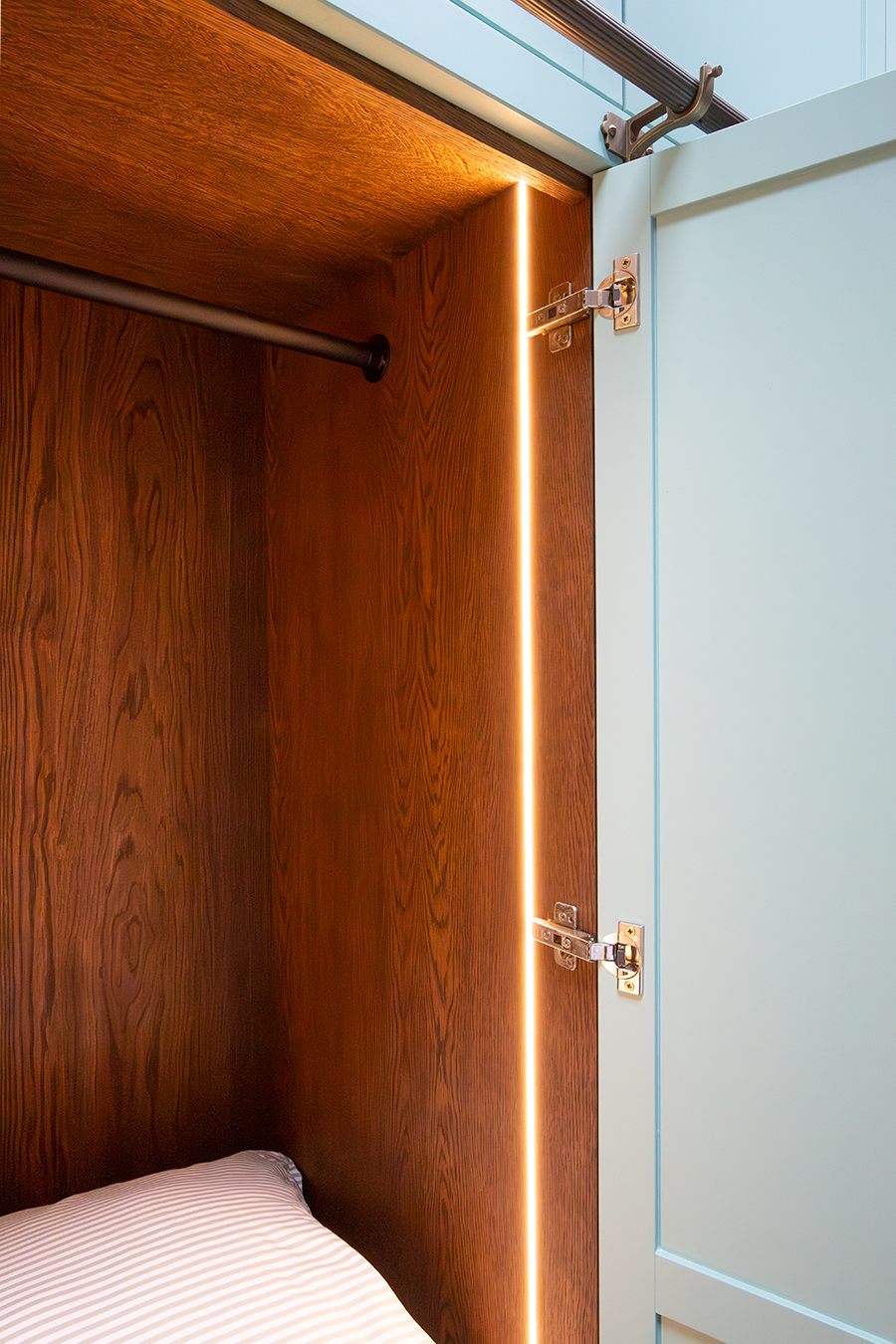 A photo of the same bedroom as before showing a close up of the LEDs inside the wardrobe.