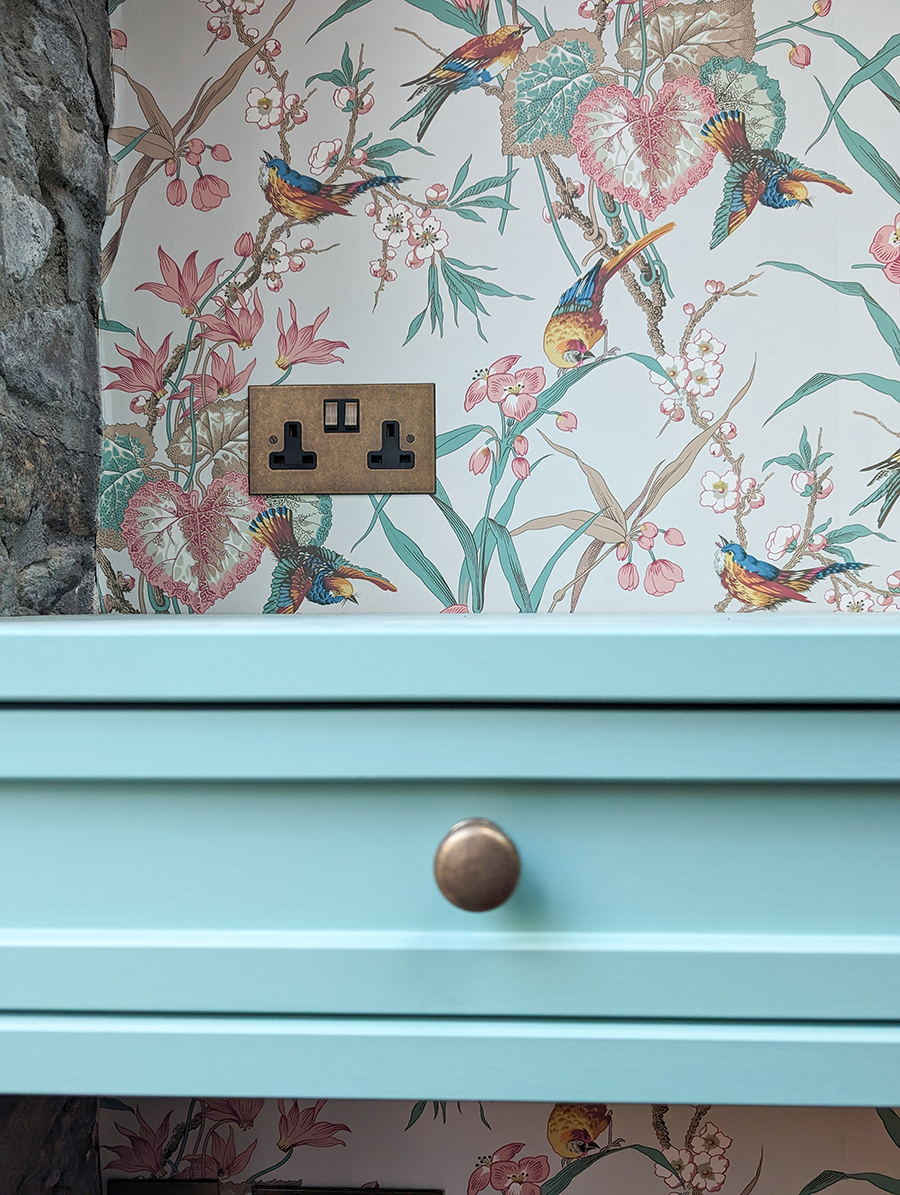 A close up photo showing the plug socket above the dressing table.