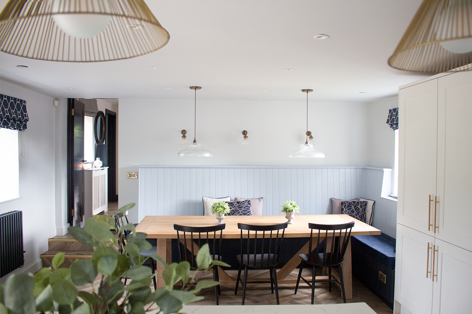 A photo of a kitchen project with lots of lighting options - ceiling, pendant, and wall lights.