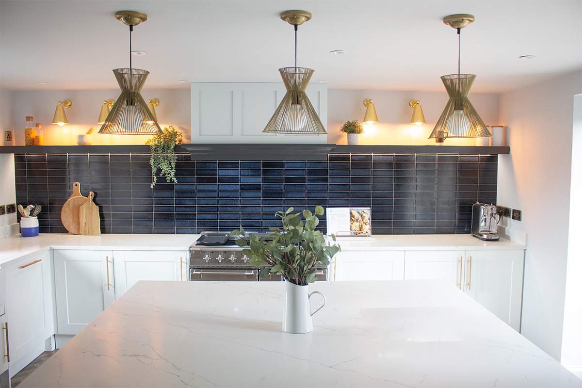 A photo showing the kitchen with lights over island, under and above the shelves, and on the ceiling.