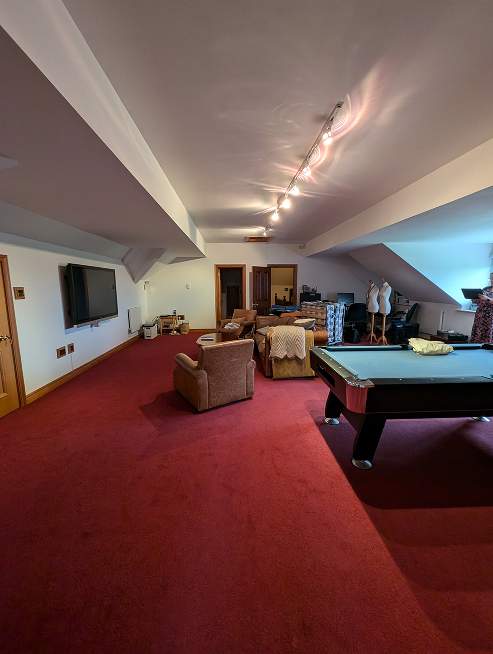 A photo showing the room before work started, with white walls and clutter.