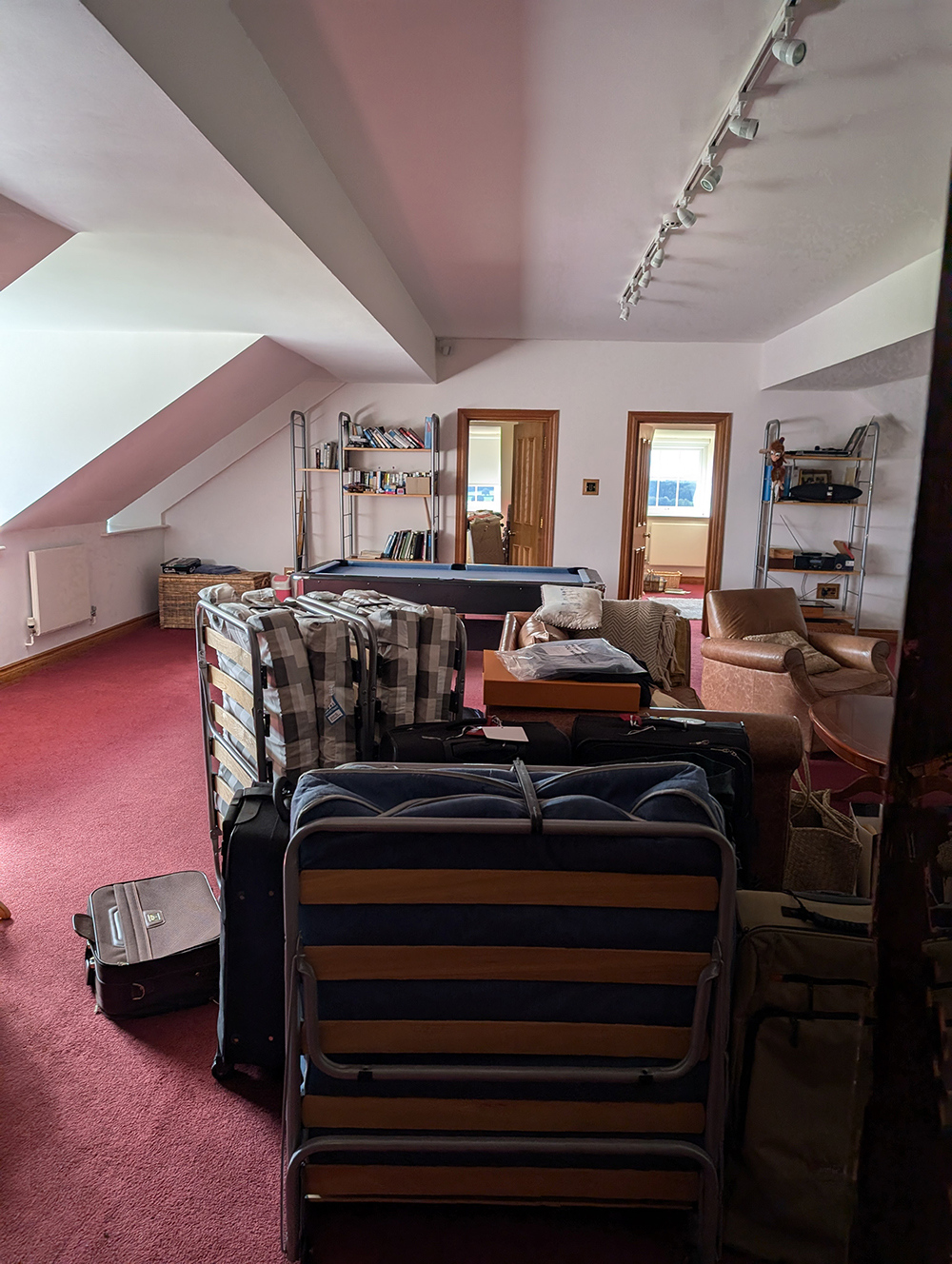 A photo showing the room before work started, with white walls and clutter.