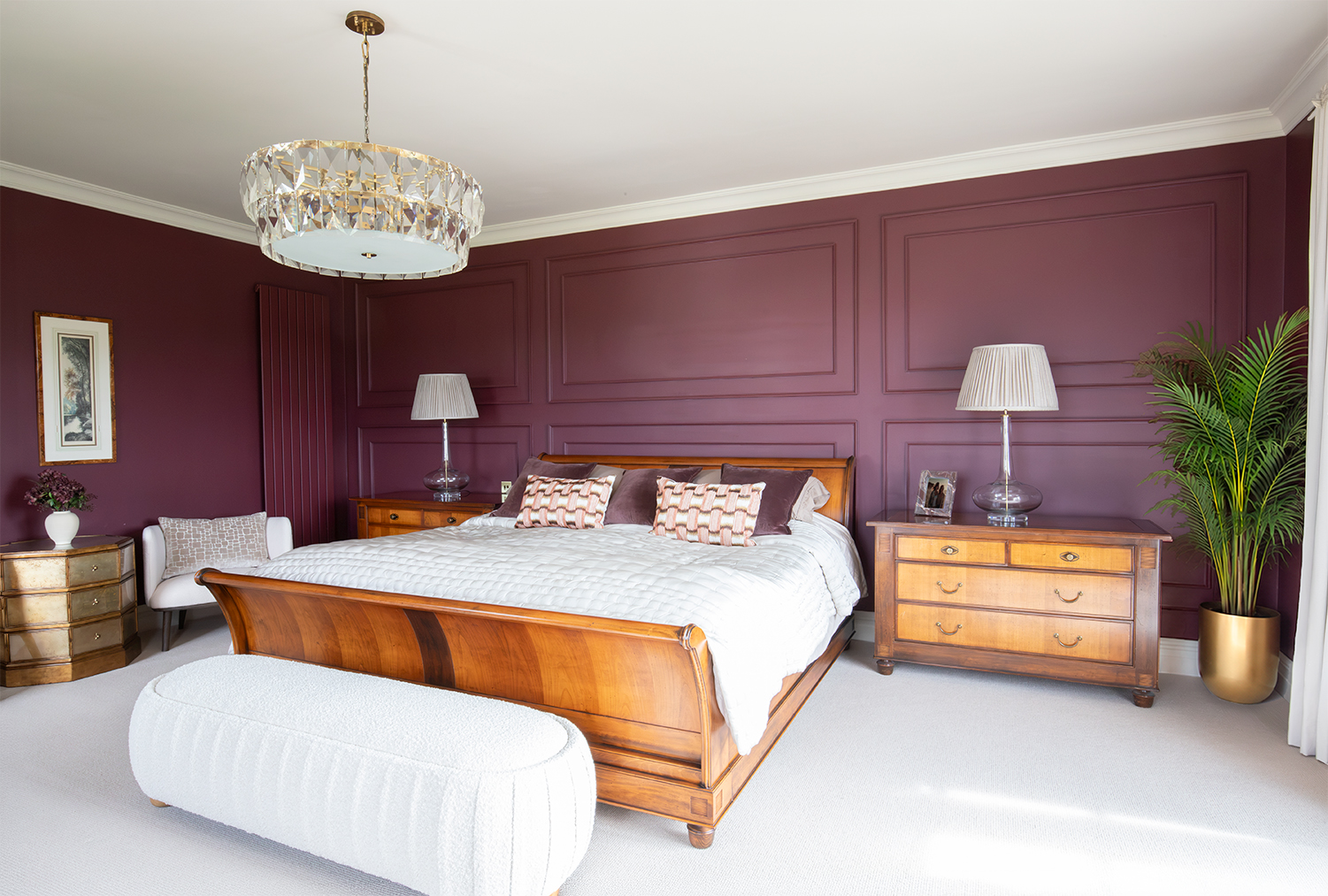 A photo of a bedroom with deep burgundy walls and a cream loop carpet.