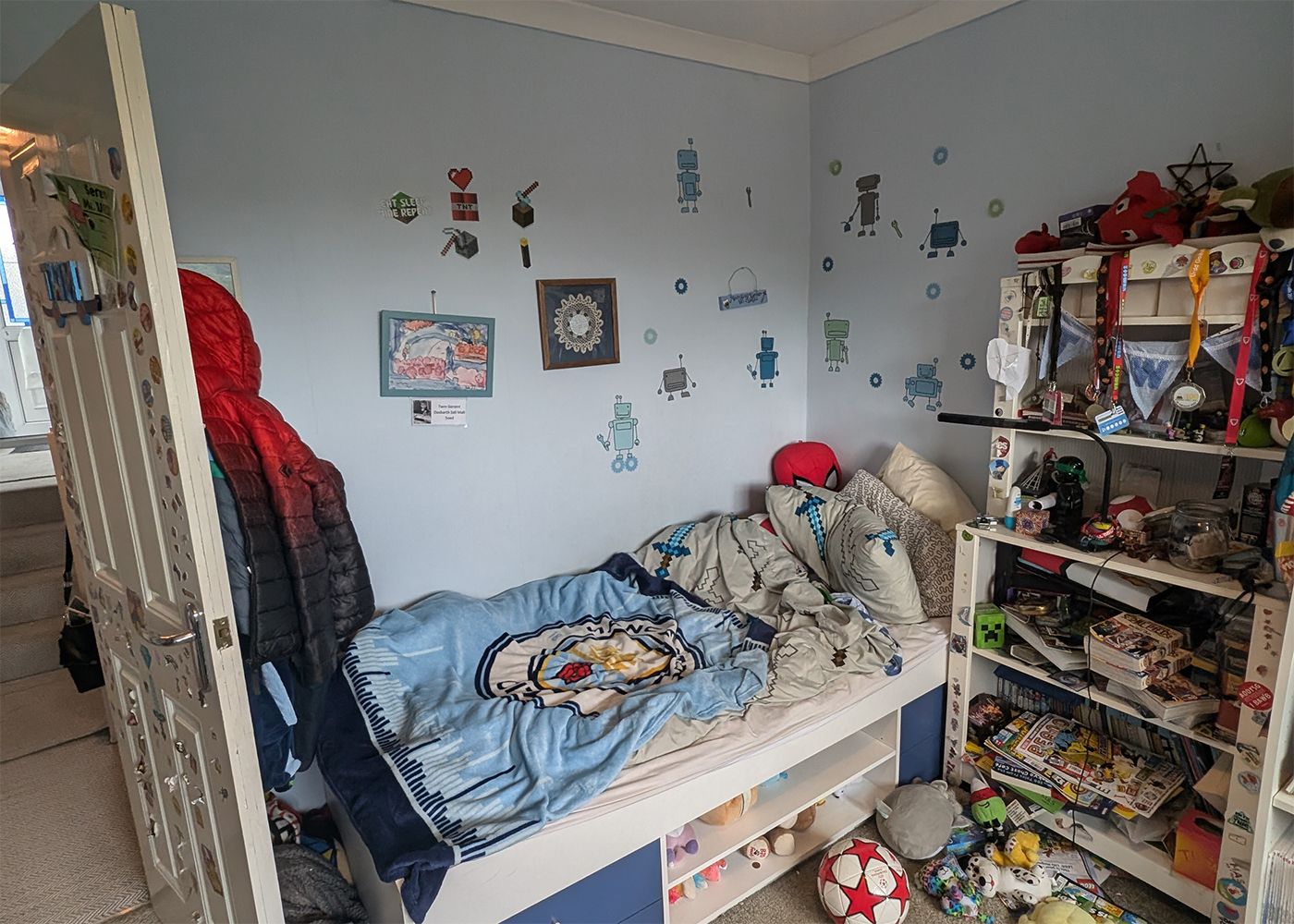 A before photo of the same room painted pale blue with lots of clutter.