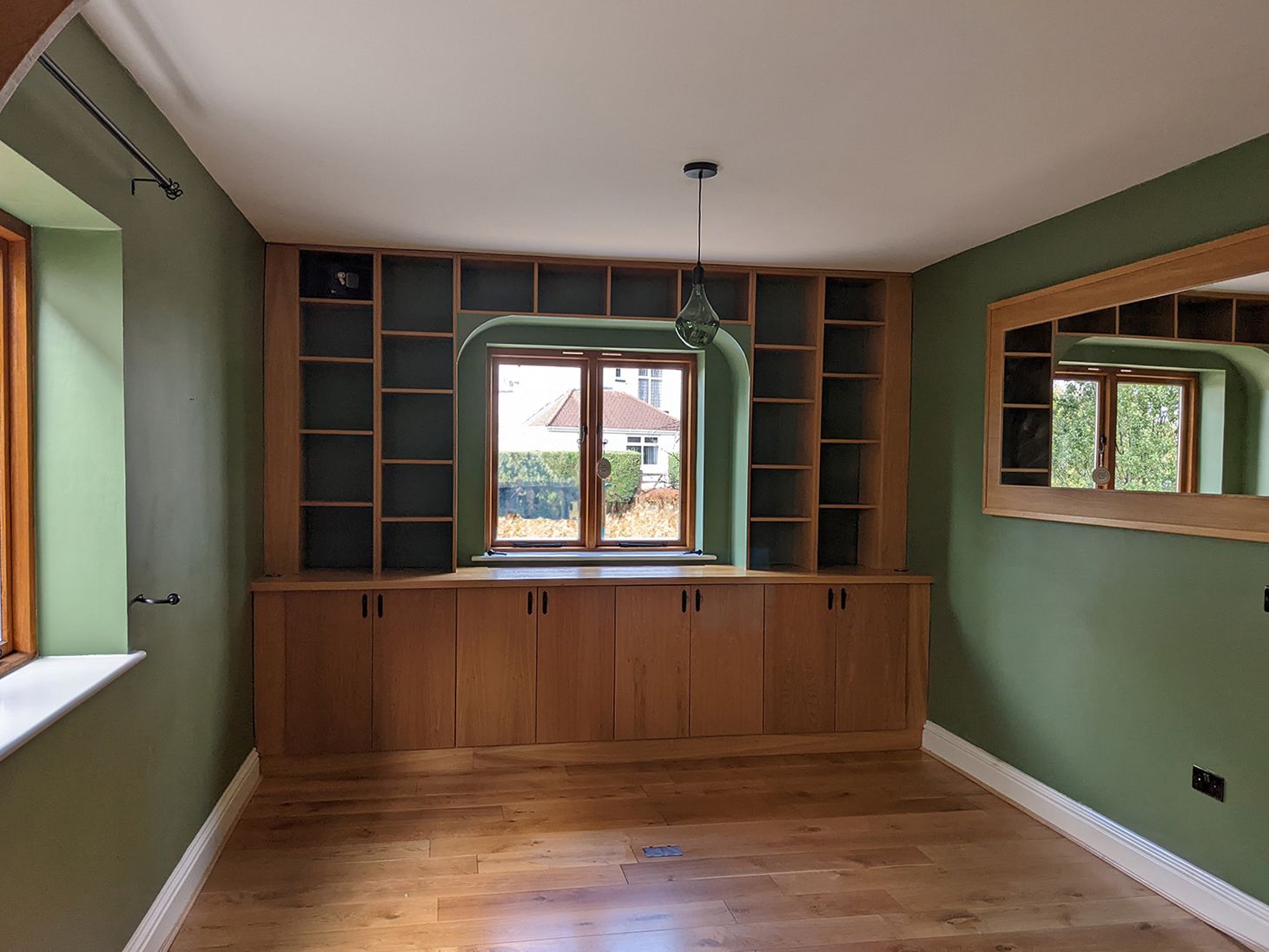 A before photo of the study with green walls and green glass lighting.