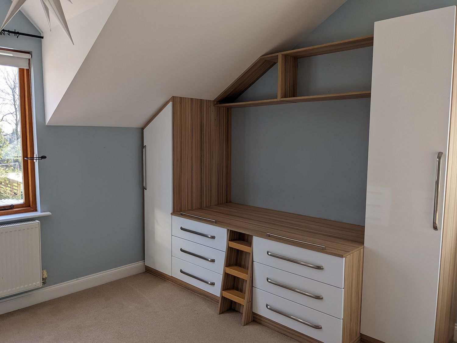 A before photo of the bedroom which had cold blue walls and built in beds.