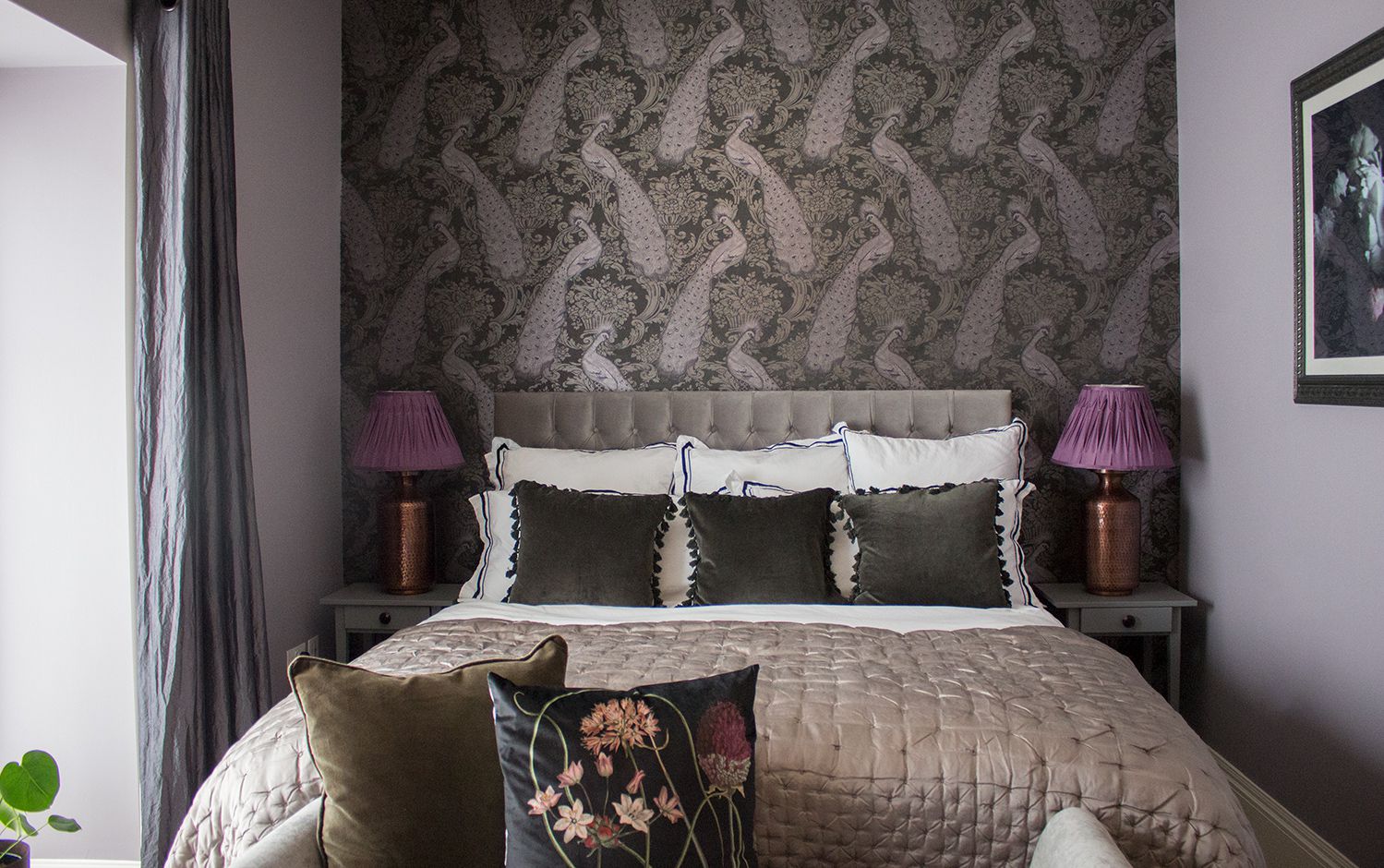 A photo of the bed with new headboard, statement wallpaper and luxury bedding.