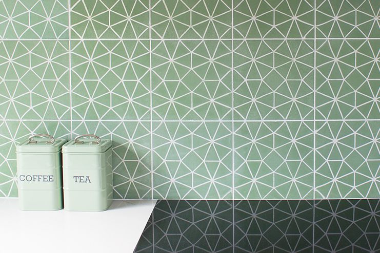 A photo of the green geometric tile splash back in the kitchen area.