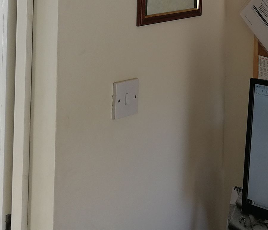 The previous light switch was a standard white one.