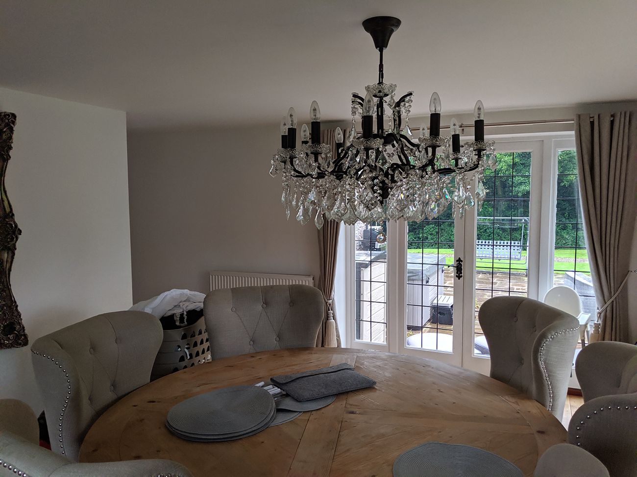 The before photo shows the same view with a dining table and large grey chairs.