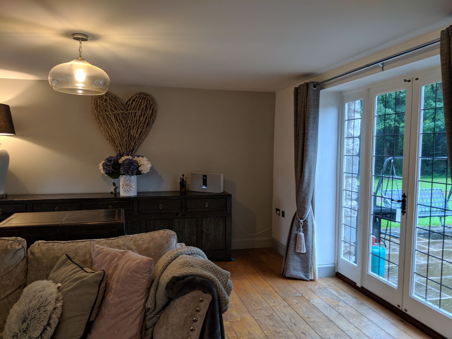 A before photo of showing the back wall of the room and the French doors leading to the garden.