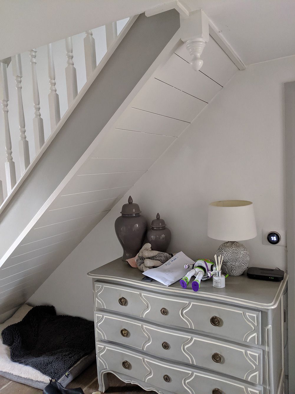 The area under the stairs before the built in storage, seating and wine rack were added.