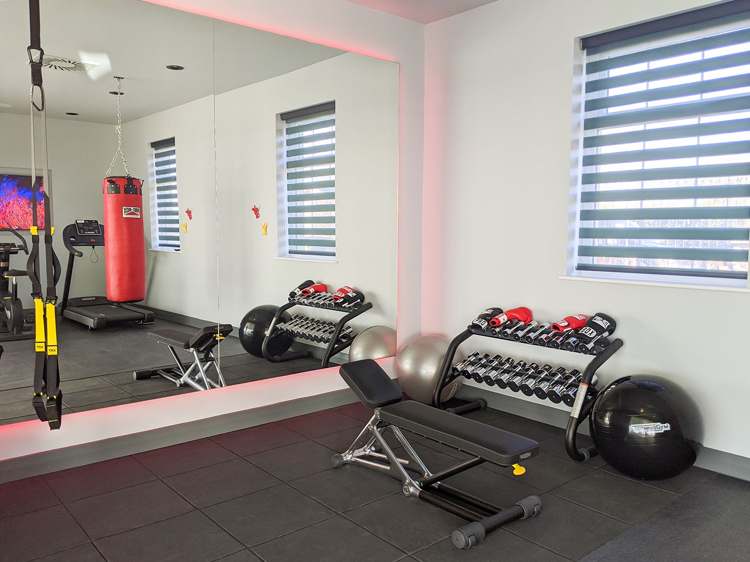 A photo of the corner of the gym, showing the punchbag and some of the equipment.