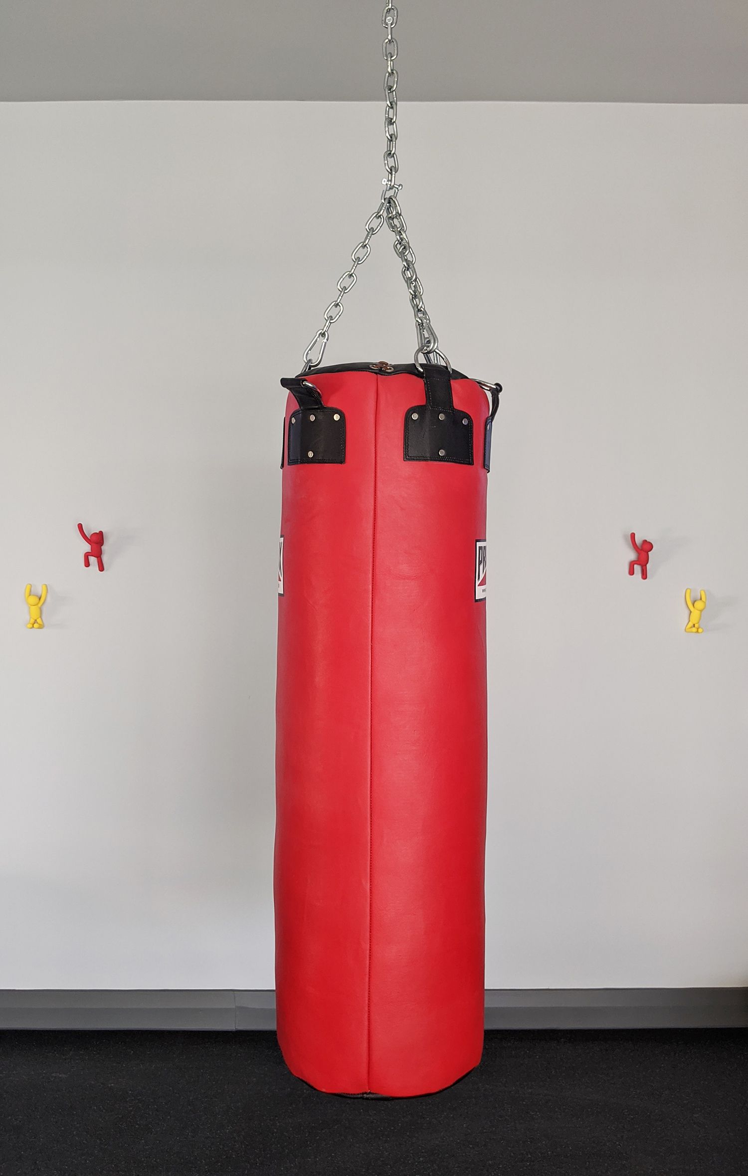 A close up of the red punch bag in the gym.