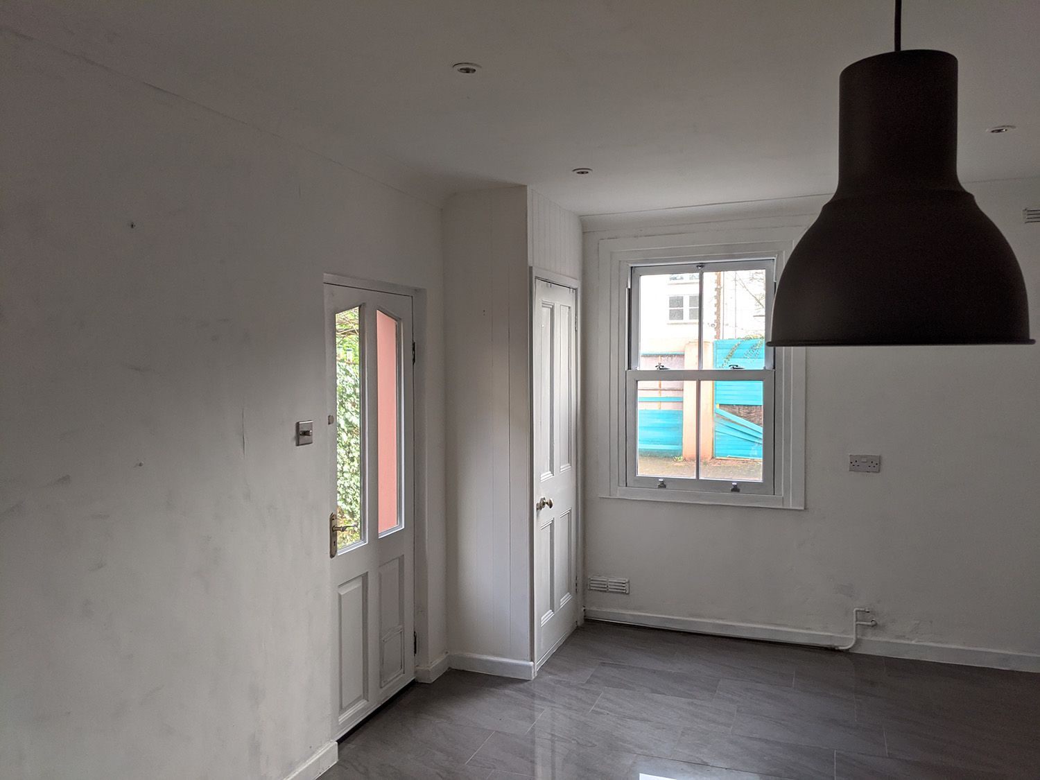 The kitchen before the extension was built, which was grey and bland.