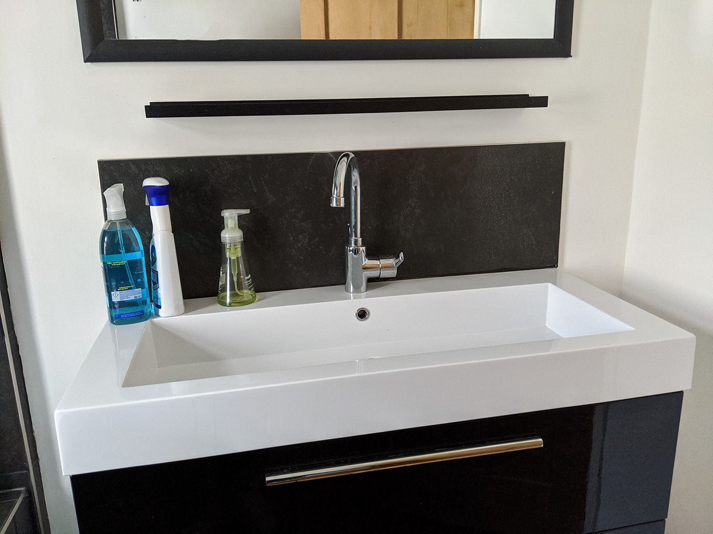 The old bathroom sink was glossy black and too big for the room.